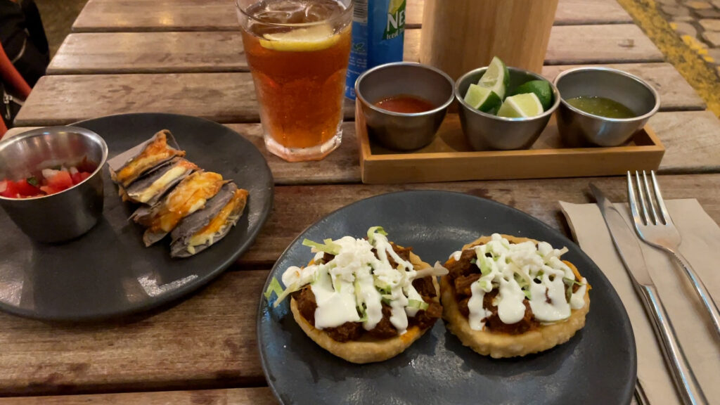 Mexican food: tacos and tortillas served with lime, sauces and ice tea.